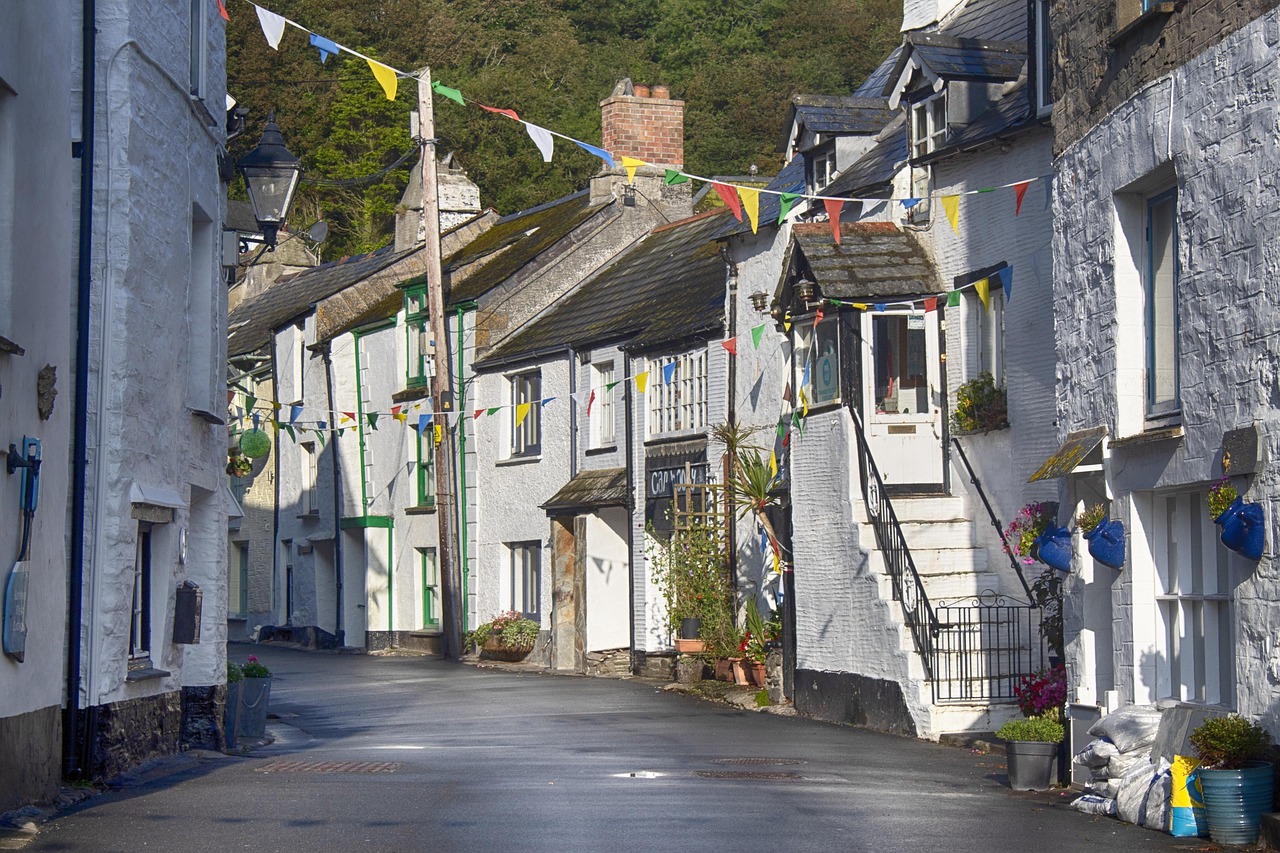Historic whitewashed cottages and village street in Cornwall, typical setting for commercial properties in heritage areas