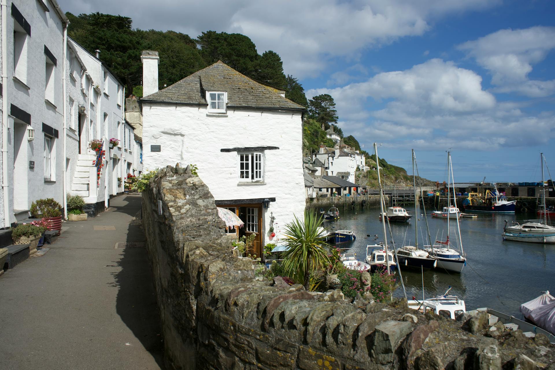 Commercial property buildings overlooking a harbour in Cornwall, representing landlord compliance and property management